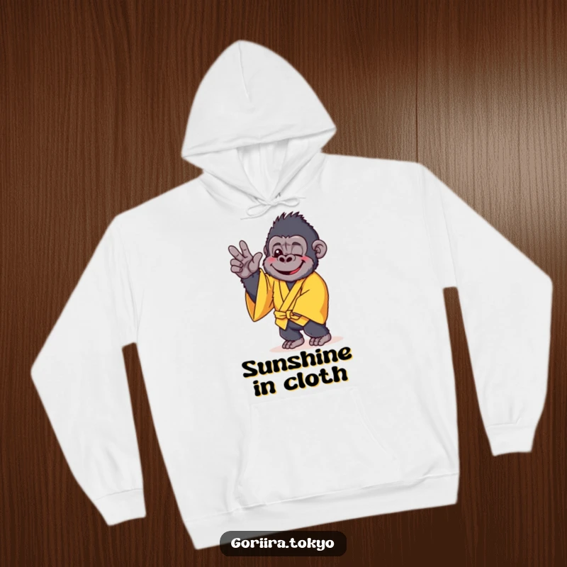 Funny hoodie design: a cheerful gorilla in a yellow kimono, striking a gentle and relaxed pose, radiating warmth.